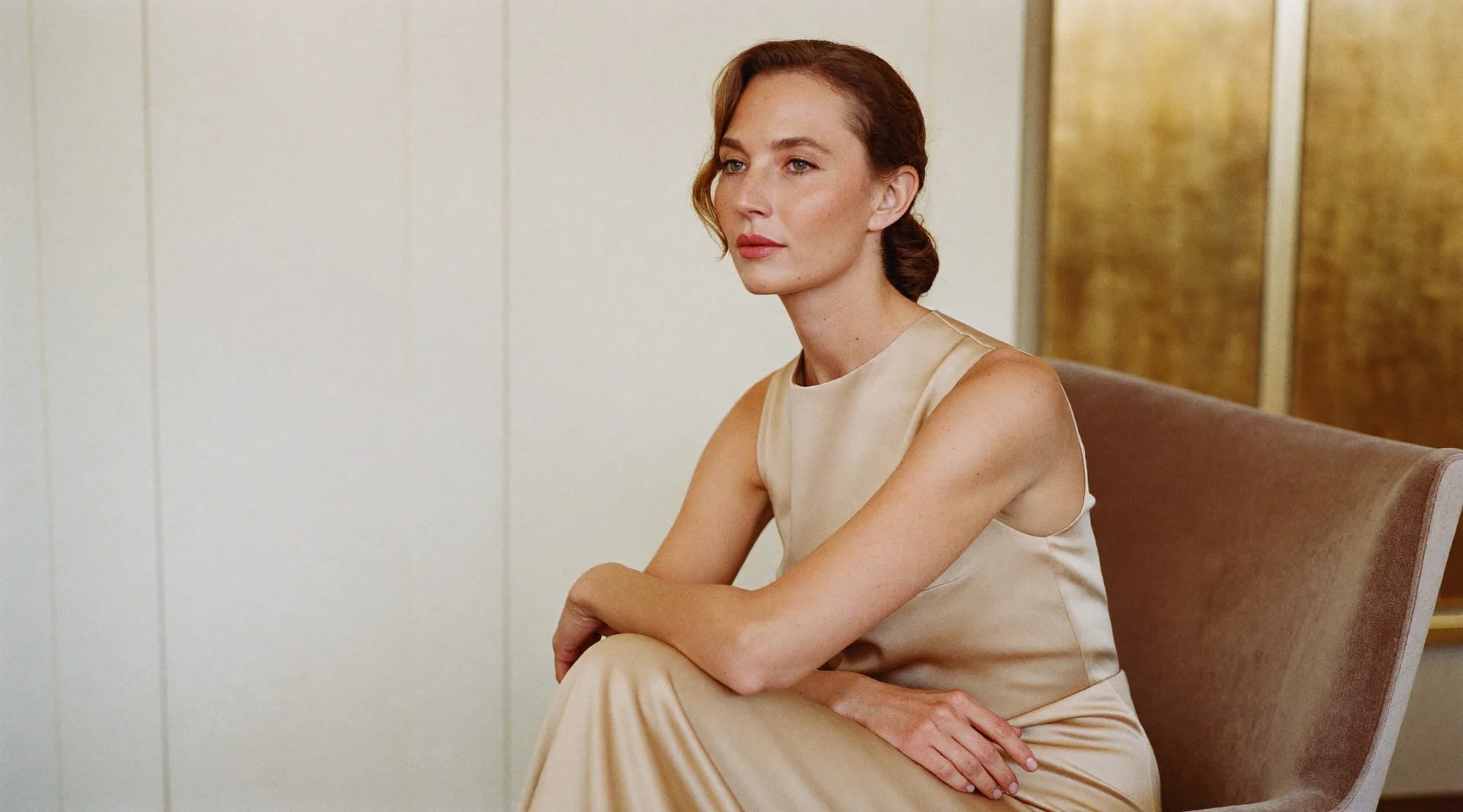 A poised, confident woman in champagne silk